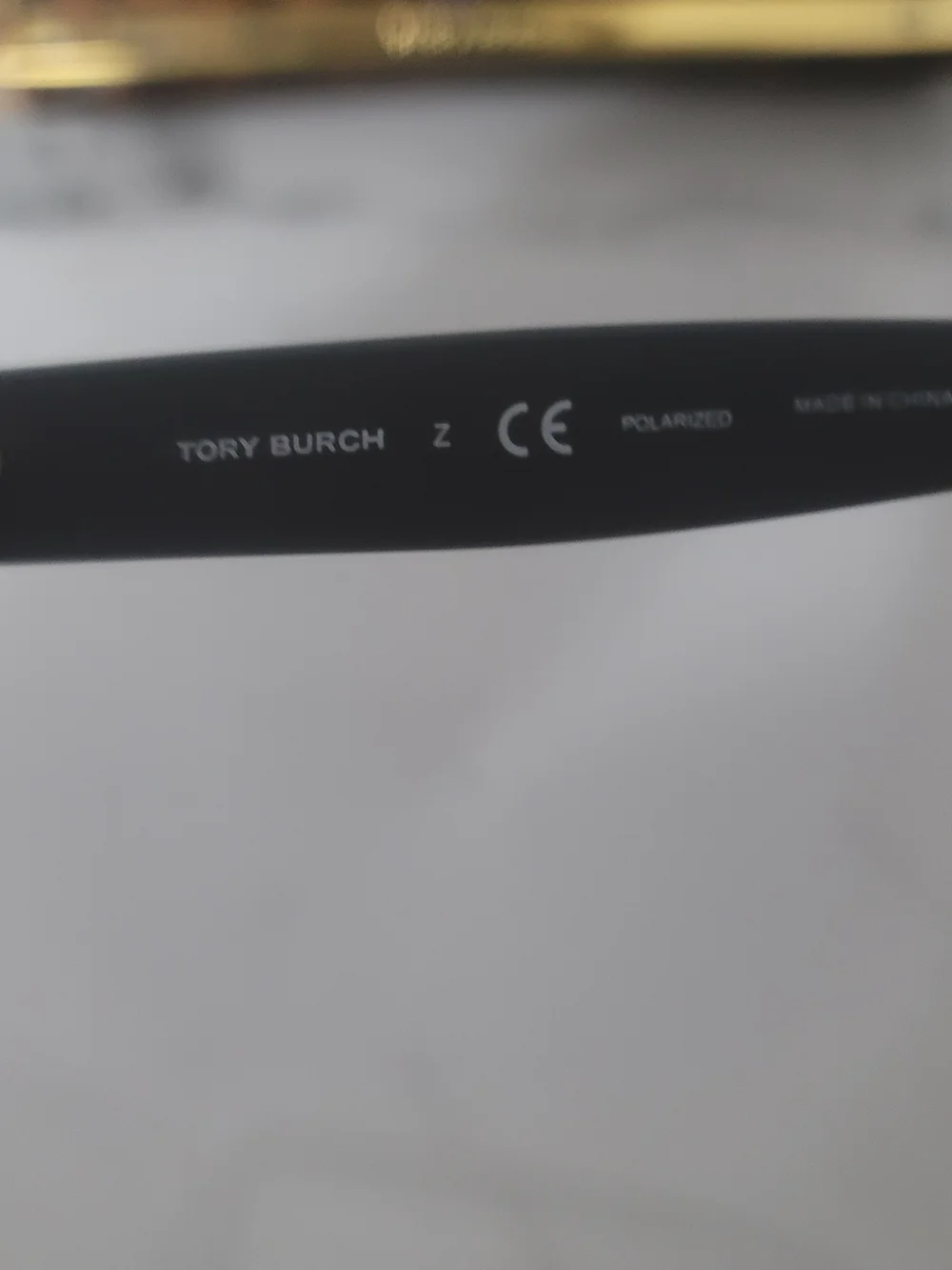 Tory Burch Black Frame Sunglasses with Blue Mirrored Lenses